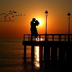 Couple on a dock at sunset
