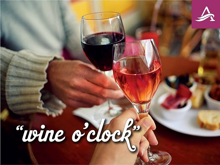 A couple toasting “Wine o’clock”