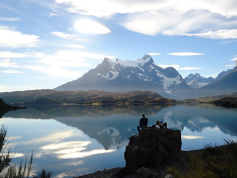 Hikers admiring the scenery while trekking at Torres Del Paine National Park.
